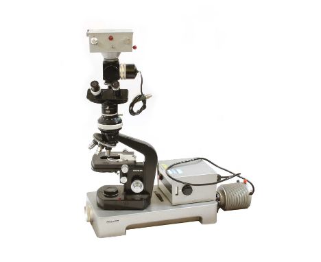 A Wild Heerbrugg Ltd. M20 microscope and accessories, including Universal Lamp, 3 x Phasenkontrast boxes, a Zeichentubus box,