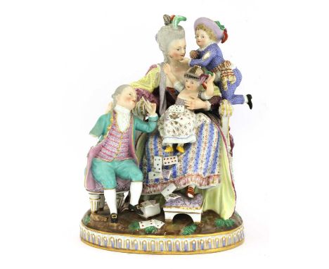 A Meissen porcelain group, 19th century, a mother seated with her three children, crossed swords mark, incised 'E 69', impres