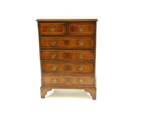 A George III style inlaid mahogany chest of drawers, of small proportions, the moulded rectangular top over two short drawers