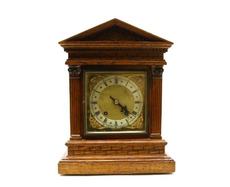 An oak cased mantel clock, early 20th century, the eight day movement striking on two gongs, stamped 'W&amp;H SCH', the gilt 