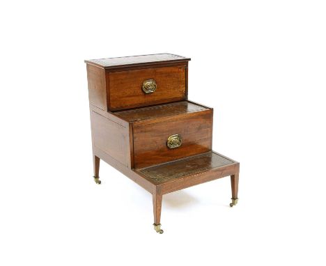 A set of Edwardian mahogany and leather library steps, the upper step with a cupboard and the middle a drawer, each set with 