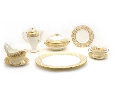 A Wedgwood 'Gold Florentine' bone china dinner and coffee service, comprising: twelve dinner, dessert and side plates, eight 
