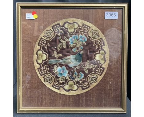 A Chinese embroidered silk panel with bird and flowers, in blue teal and mauve silk on a brown silk background, outlined with