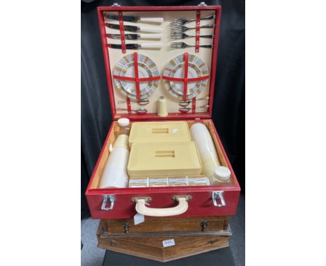 A Vintage red picnic hamper and two vacant wooden canteen cases. (3)