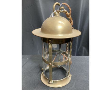 AN EARLY 20TH CENTURY BRASS HALL LANTERN, cylindrical form with domed shade. 28cm high, excluding chain