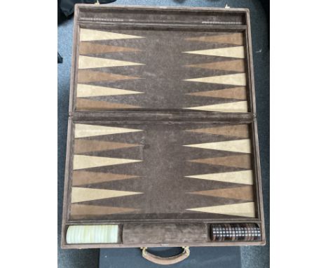 A suede leather cased backgammon set, by Zarach, complete with counters. 62cm by 40cm
