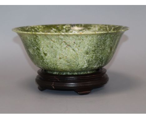 A modern Chinese spinach jade/bowenite bowl with hardwood stand, boxed Diameter 21cm