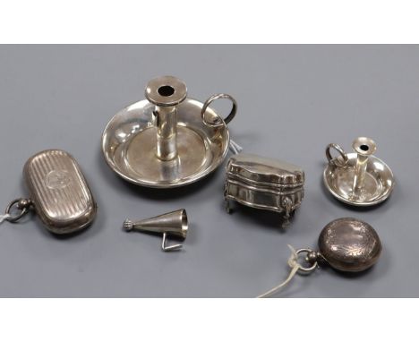 A silver combination stamp/sovereign case, another sovereign case, two miniature chambersticks and a patch box (a.f.)