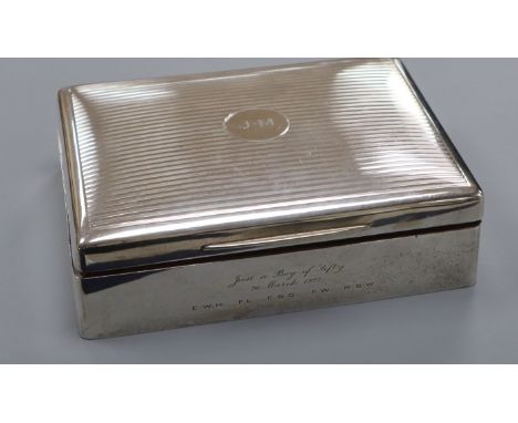 A Mappin &amp; Webb engine-turned silver cigarette box, initialled and with presentation inscription 17.7cm.