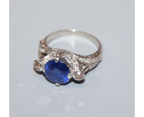 A white metal synthetic? sapphire and diamond set dress ring, the shank stamped 'PALL'?, size K.