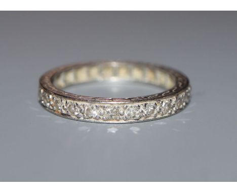 A white metal and diamond set full eternity ring, size K/L.