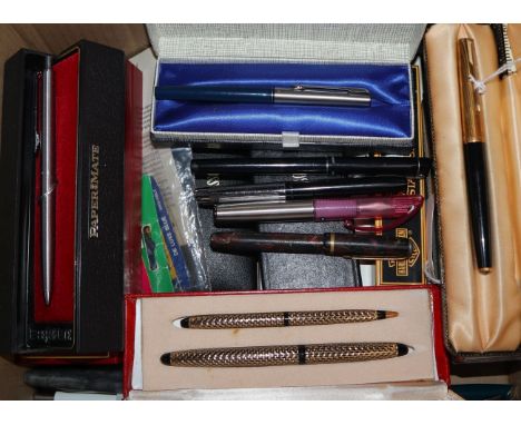 A collection of fountain and ballpoint pens, some boxed, including Parker 51 and 61, Parker Vacumatic, Lady Sheaffer set, Bur