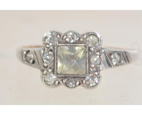 An Art Deco 9ct gold and silver ring with paste stones. Marked 9ct and Sil. Tests 9ct and silver. Size M.