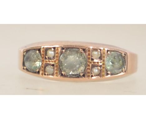 A Victorian hallmarked 15ct gold ring set with seed pearl and peridot. Hallmarked Birmingham. Size Q. Weight 2g.