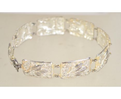 A vintage 800 silver pictorial link bracelet with spring hoop clasp. Marked 800. Measures 7.5 inches.