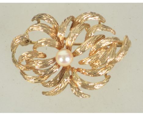 A hallmarked 9ct gold and pearl brooch with trombone clasp. Import marks for London. Maker H.G. Measures 3.5cms. Weight 3.6g.