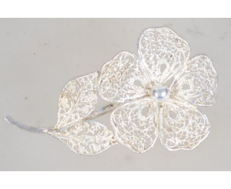 A vintage silver filigree flower brooch with roller clip clasp. Marked Sterling Germany. Measures approx 6cms. Weight 5.4g.