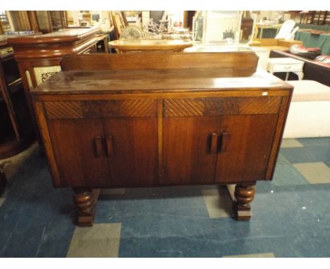 An Art Deco Oak Sideboard with Bulbous Supports.