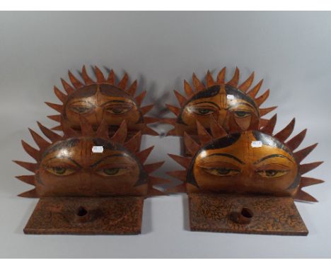 A Set of Four Indian Metal Candle Stick Holders Decorated with Face Painted on Sun.