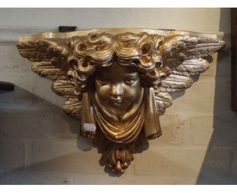 A Gilded Ceramic Cherub Wall Sconce.