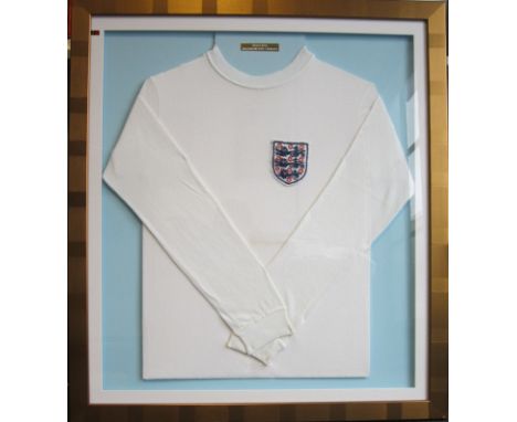 COLIN BELL ENGLAND SHIRT Framed, glazed England shirt worn by Colin Bell whilst playing for England. White long-sleeved Umbro