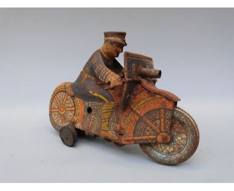 Louis Marx & Co clockwork tinplate Police Department police officer riding a motorbike with front mounted gun. 