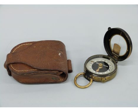 A cased military style compass