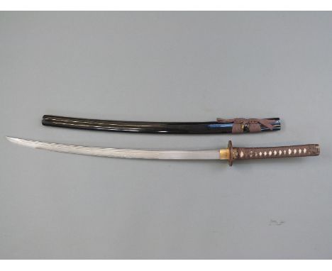 A Samurai sword with decorated guard and lacquered scabbard, blade length 72cm, with case 