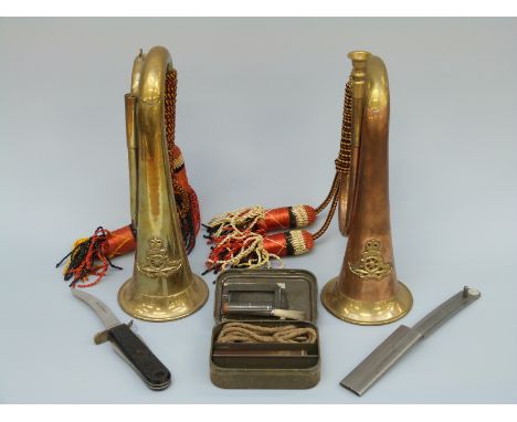 A collection of military items to include two Royal Artillery brass and copper crested bugles, metal sheathed army knife, rif