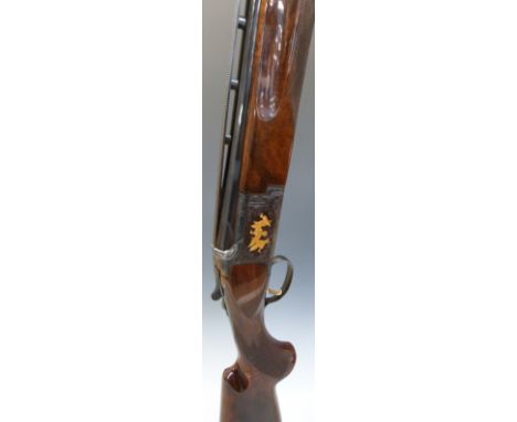 Browning 12 bore over and under shotgun with all over scrolling engraving and scenes of birds engraved to the lock highlighte