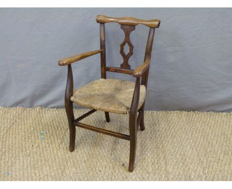 A mahogany child's chair with rush seat and Pratt Brothers, Streatham enamel badge to underside 