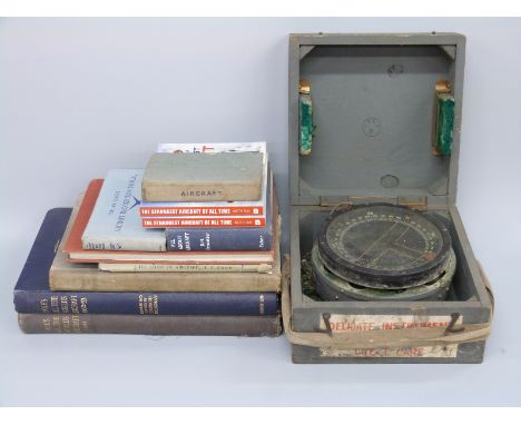 A cased P10 military aircraft compass and books