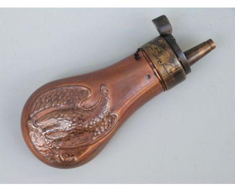 Copper and brass pistol powder flask with embossed decoration of an American style eagle holding a revolver and a powder flas