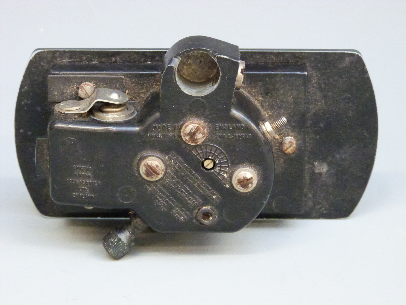 A classic or vintage car rear view mirror with inbuilt clock