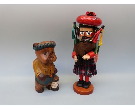 Steinbach wooden bagpiper puppet (40cm tall) together with a carved wooden model of a pig golfer, 26cm tall