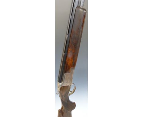 Browning B2 12 bore over and under shotgun with engraved scenes of birds to the lock, chequered semi-pistol grip and forend, 