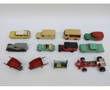 Twelve Dinky Toys diecast model vehicles and accessories including Shell van, Express Dairy milk float, Royal Mail van, ambul