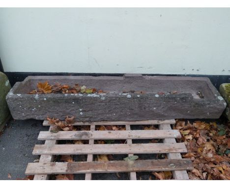 A rectangular carved natural stone trough (L160 x W40 x H24cm)