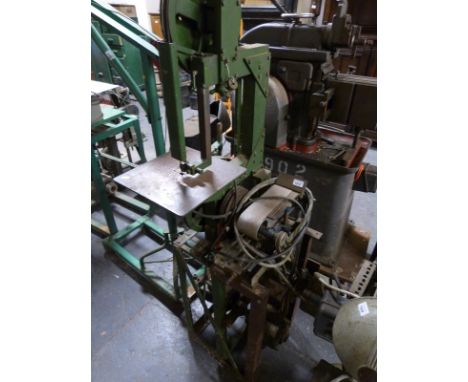 A band saw and belt sander on combined stand 