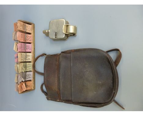 A Williamson ticket printer, rack of Pearce's Motors Ltd tickets and a leather pouch
