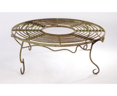 Circular garden bench, the circular bench with a open middle section raised on scroll supports, 120cm wide