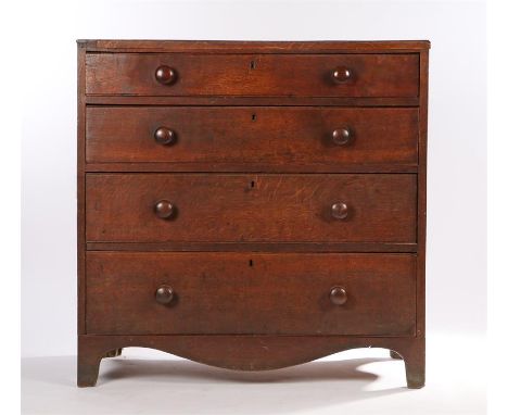 George III oak chest of four long drawers, with turned handles, on a shaped apron and bracket feet, 96.5cm wide