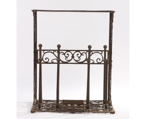 Wrought metal scroll work boot rack with scraper, the rectangular shelf top above scroll design, eight rods and scraper to th