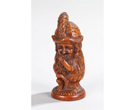 Treen pot and cover carved in the form of a seated bearded nymph wearing a hat with feather plume playing a flute, 11cm high