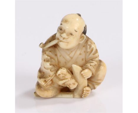 Japanese Edo period ivory netsuke depicting a seated farmer smoking a pipe whilst sharpening a sickle, signature to the rever