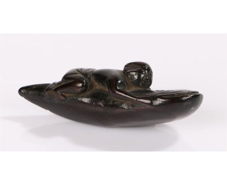 Japanese Edo hardwood Netsuke representing Kadori Myojin sitting on a namazu while he is trying to keep down the earthquake f