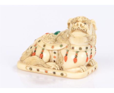 Japanee Meiji period netsuke, the ivory netsuke as a shishi with cloak inlaid with coral and malachite 3.5cm wide