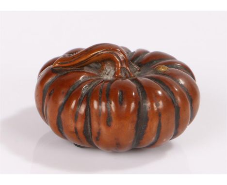 Japanese Edo period netsuke, the wood netsuke carved as a pumpkin, the stem of which forms the himotoshi, with three bead ins