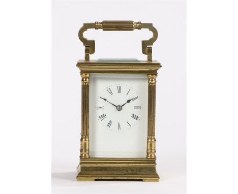 French gilt brass carriage clock, the bevelled glass top, sides, back and front with a fluted columns to the case and an arch