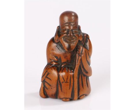 Japanese Meiji period netsuke, the box wood netsuke carved as Jurojin, seated holding a staff 6cm high
